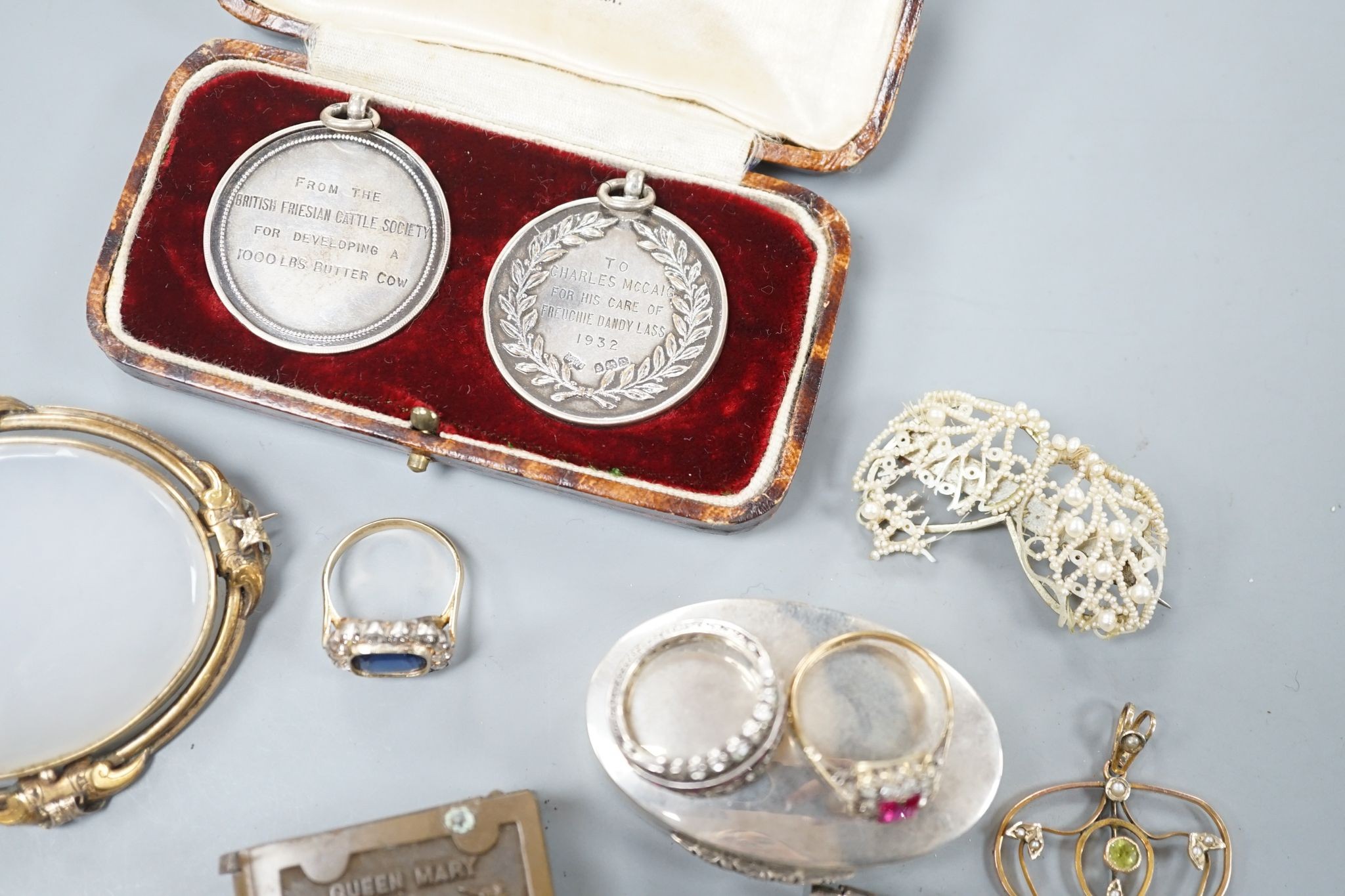 A 9ct mounted oval cameo shell brooch, 47mm, a yellow metal blue paste and diamond cluster set ring, size L, three 9ct rings and other items including silver vesta case, silver bangle and costume jewellery etc.